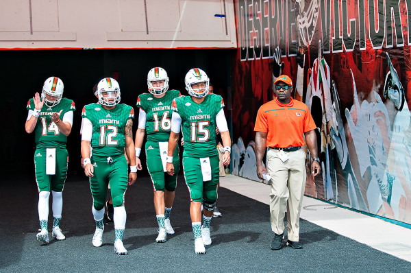 Miami Hurricanes QB #15, Brad Kaaya, leads the quarterbacks group onto the field