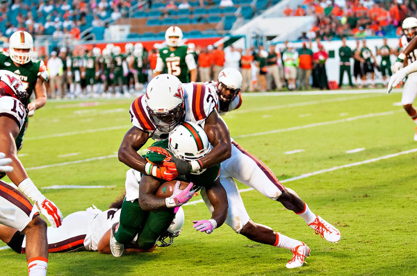 Virginia Tech LB #37, Ronny Vandyke, wraps up Miami Hurricanes RB #2, Joe Yearby