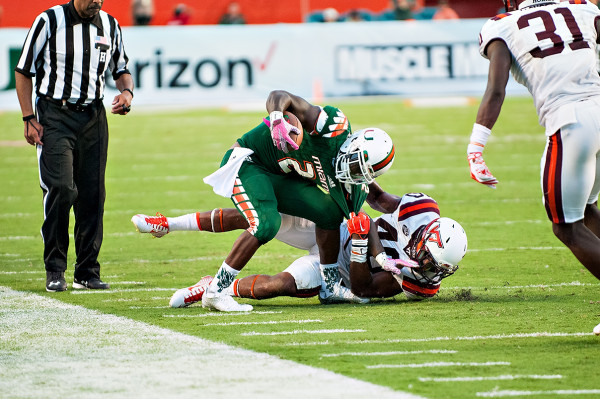 Miami Hurricanes RB #2, Joe Yearby, tries to escape the grasp of Virginia Tech LB #40, Deon Clarke