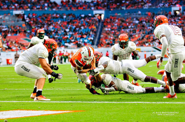 Hurricanes WR, Braxton Berrios, dives for the endzone