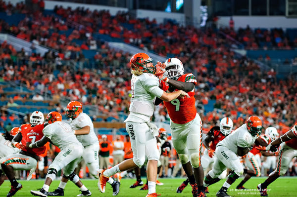 Hurricanes DL, Chad Thomas, delivers a blow to the helmet of FAMU QB, Ryan Stanley