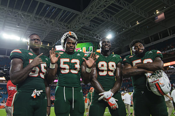 Hurricanes players pose after the game