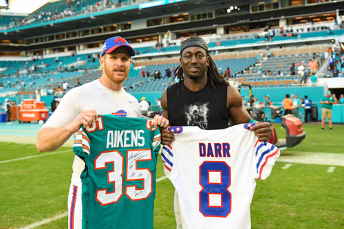 Miami Dolphins defensive back Walt Aikens (35) and Buffalo Bills punter Matt Darr (8)