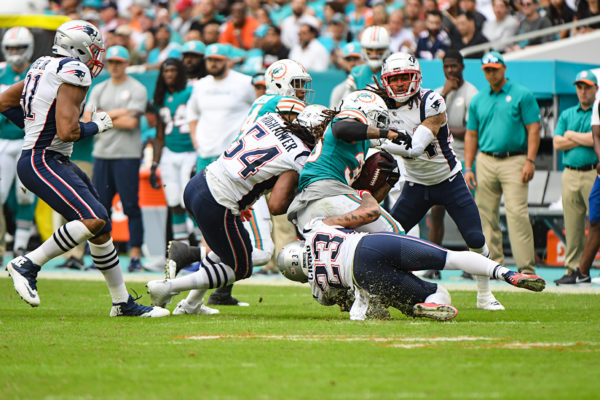 New England Patriots strong safety Patrick Chung (23) and New England Patriots outside linebacker Dont'a Hightower (54) tackle Miami Dolphins running back Kenyan Drake (32)