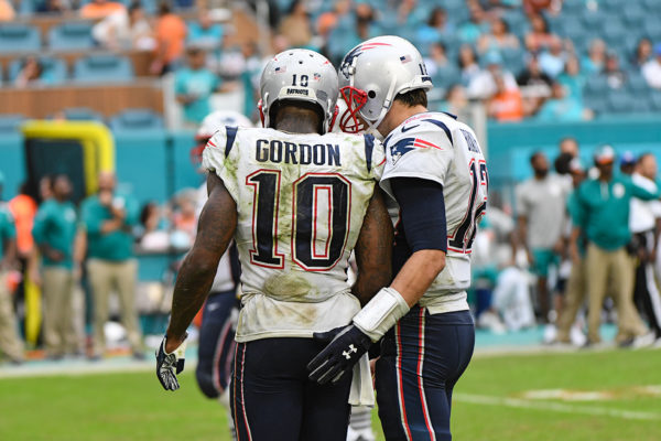 New England Patriots quarterback Tom Brady (12) and New England Patriots wide receiver Josh Gordon (10)